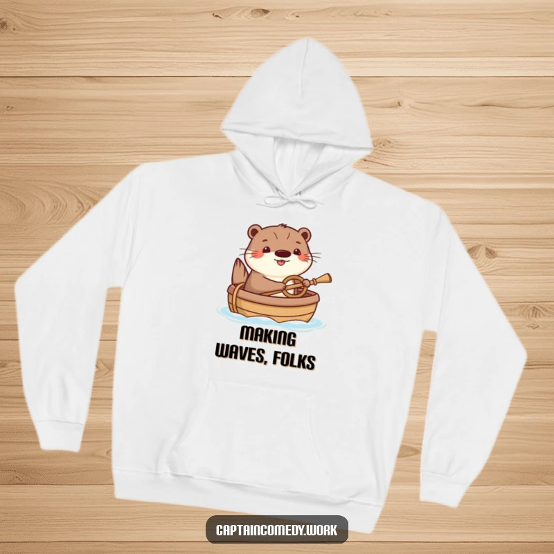 Funny Otter Hoodie: A happy otter humorously steering a small boat with a tiny oar, perfect for cozying up with a splash of aquatic joy.